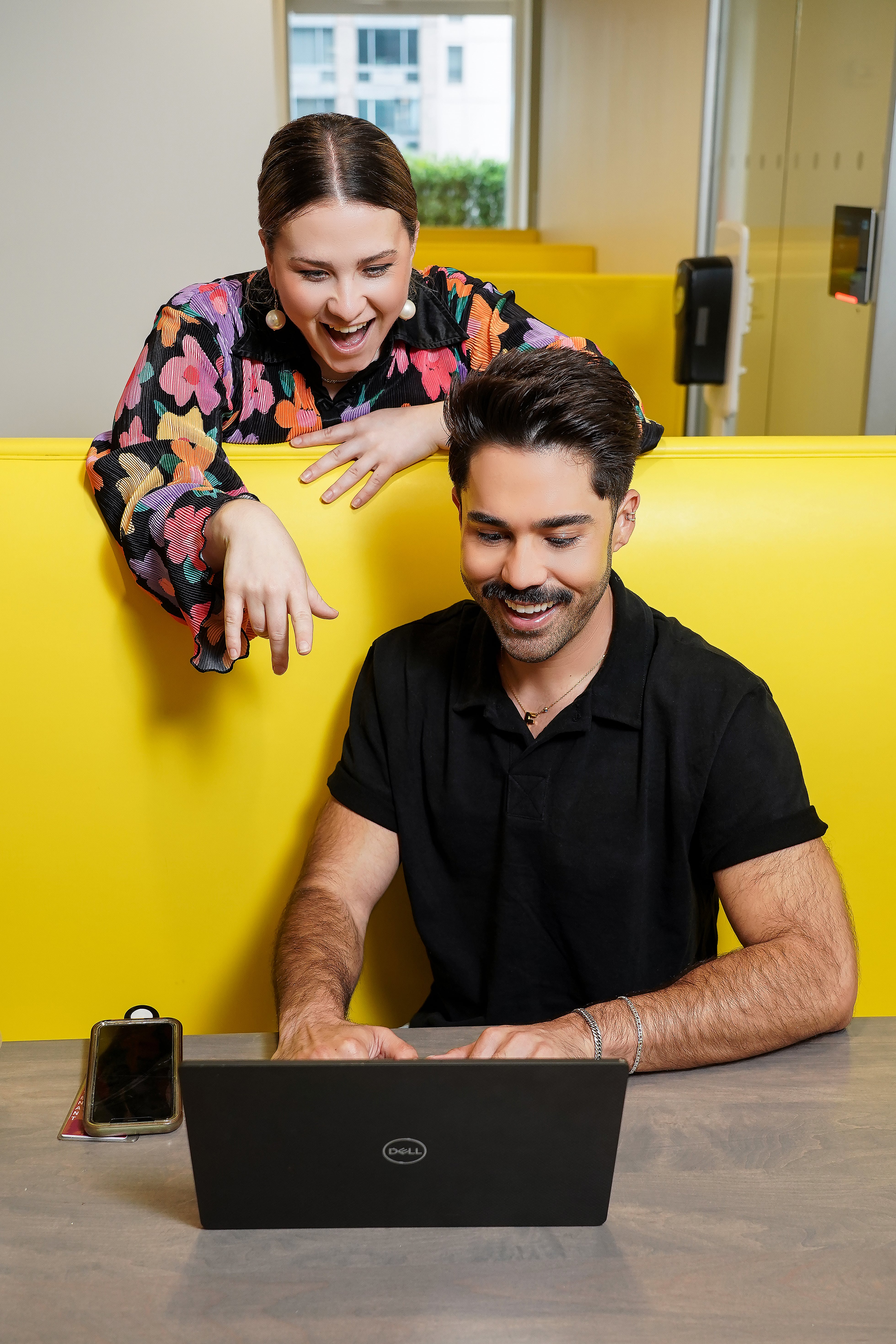 Woman and man looking at laptop screen.