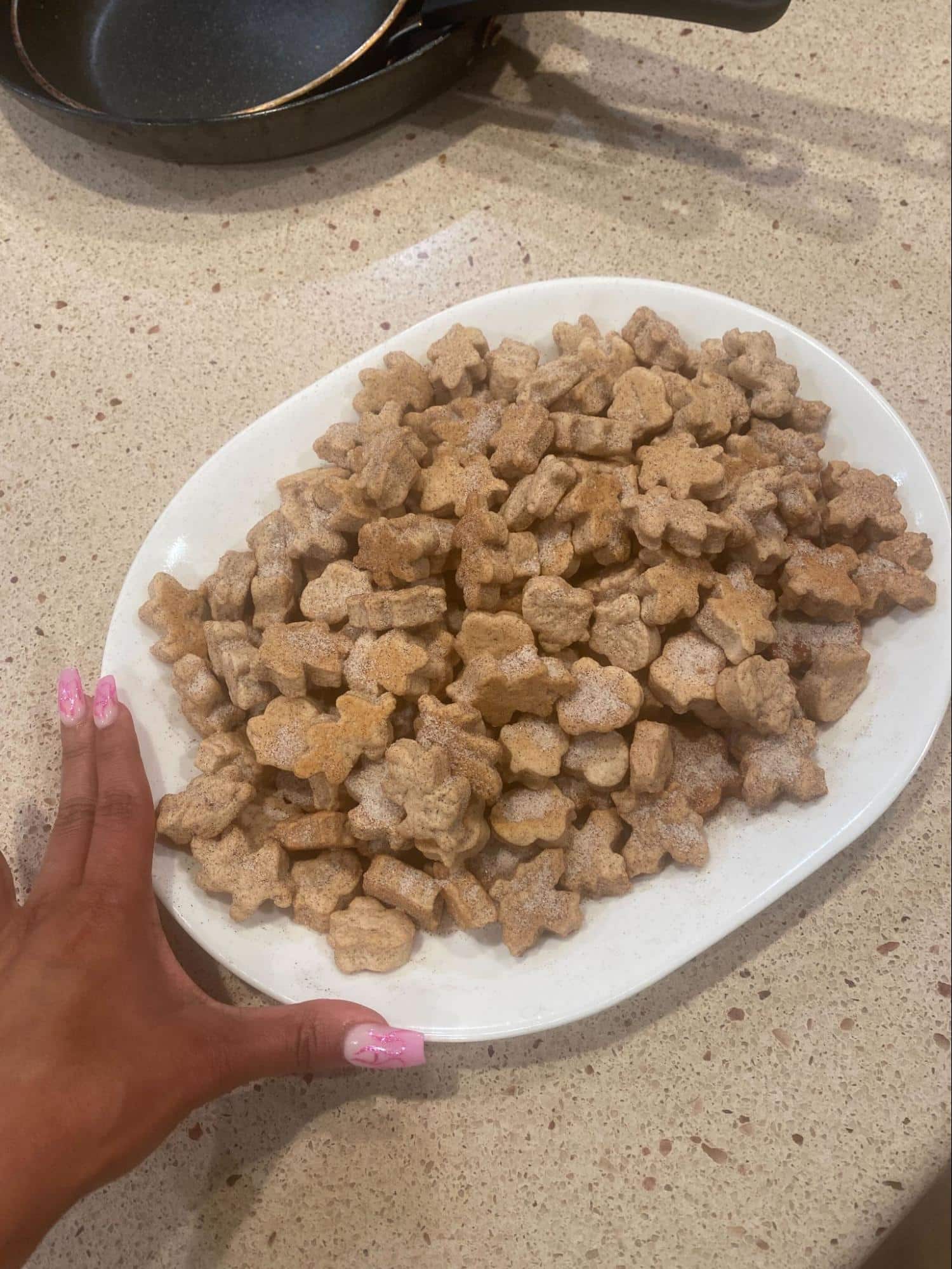 mexican wedding cookies on a white plate.